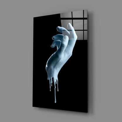Surreal white hand with blue drips on glossy black glass wall art canvas print
