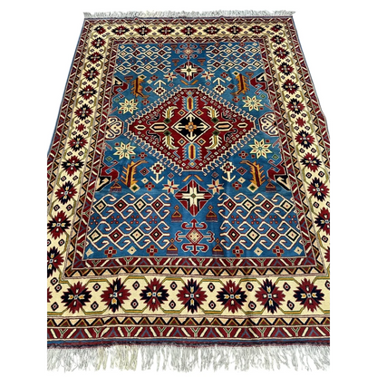 Blue and red geometric Kazak rug with cotton foundation and cream fringe