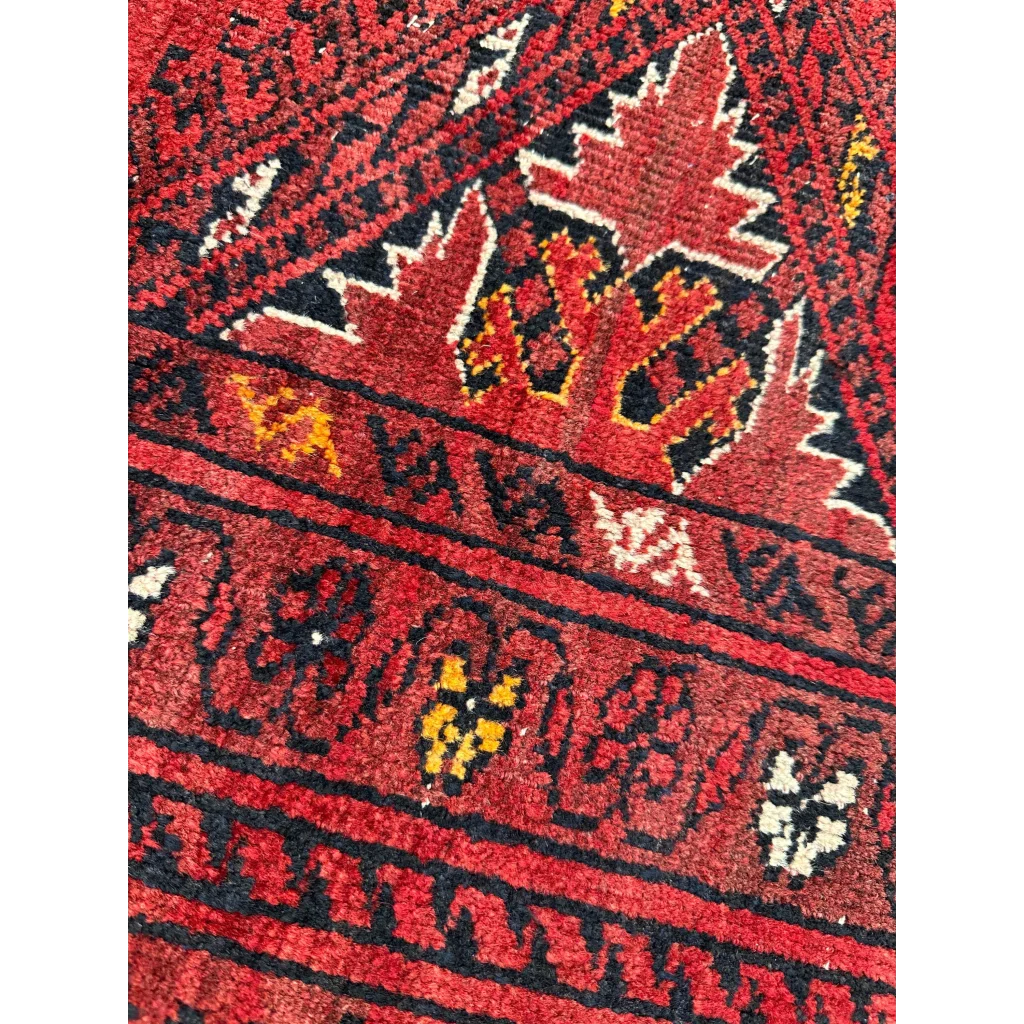 Vibrant Afghan Turkoman Waziri wool rug with red, black, yellow patterns