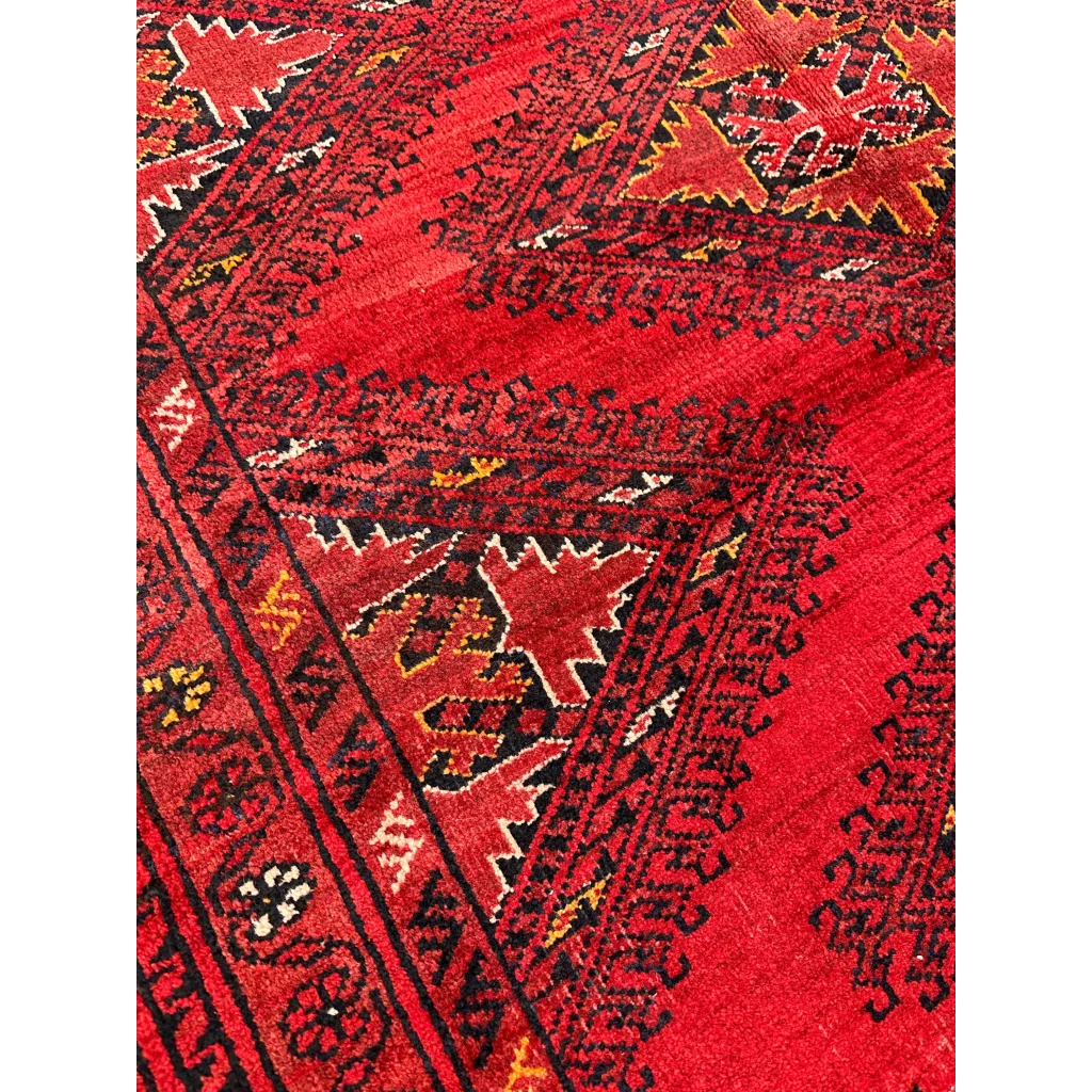 Vibrant red Afghan Turkoman Waziri wool rug with geometric floral patterns