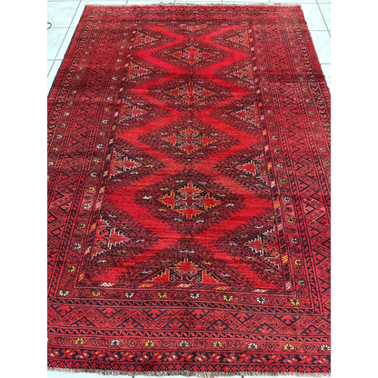 Vintage Afghan Turkoman Waziri wool rug in red with intricate motifs