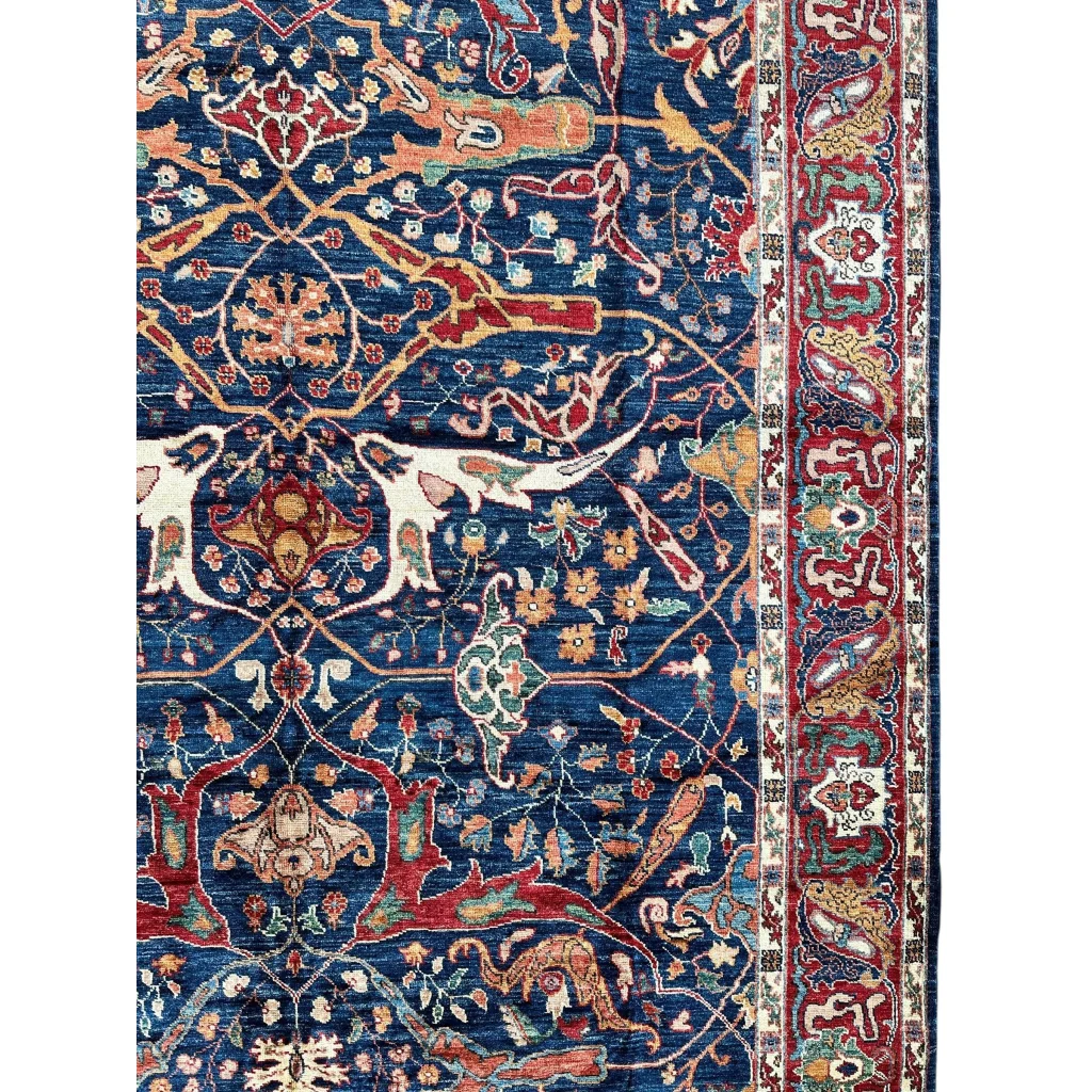 Deep blue Ghazni wool rug with intricate red, gold, cream floral motifs, 6’7’’ x 9’10