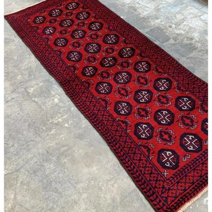 Vibrant red and navy Afghan Baluch hand-knotted wool runner with geometric patterns