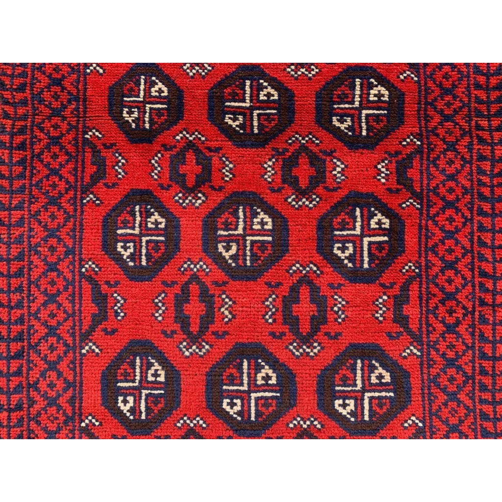 Vibrant red Afghan Baluch hand-knotted runner with navy blue and cream geometric patterns