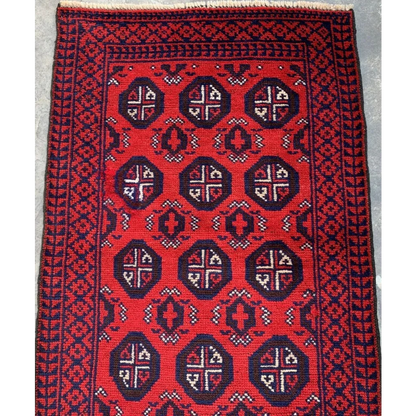 Vibrant red and navy hand-knotted Afghan Baluch wool runner with geometric tribal patterns