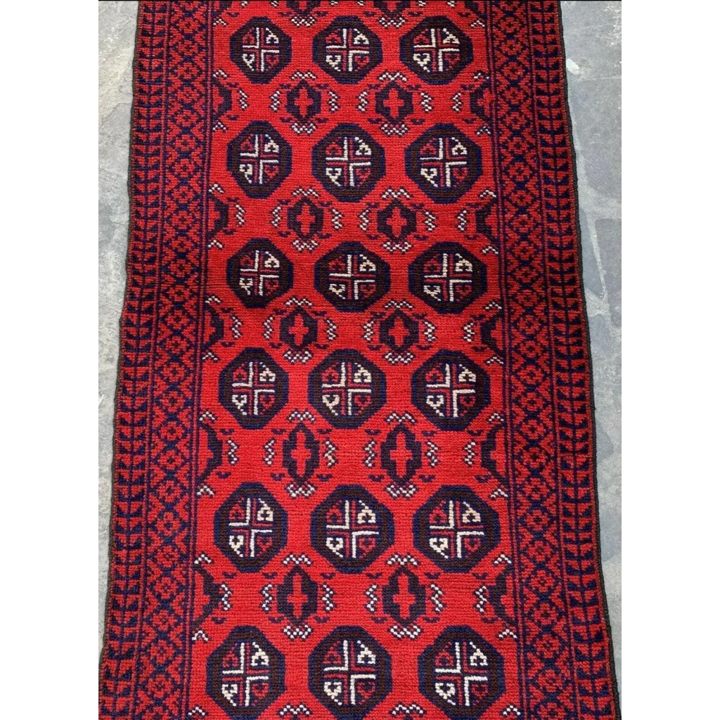 Vibrant red Afghan Baluch hand-knotted wool runner with navy geometric tribal patterns
