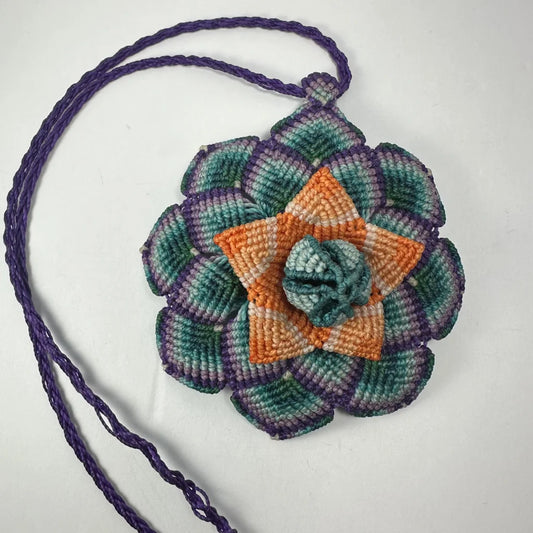 Vibrant hand woven flower necklace with teal, orange, purple crochet pouch