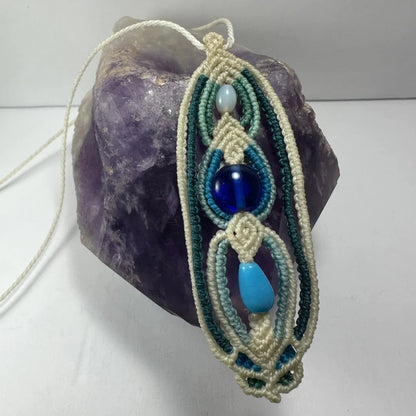 Handcrafted macrame necklace with turquoise glass beads and knotwork