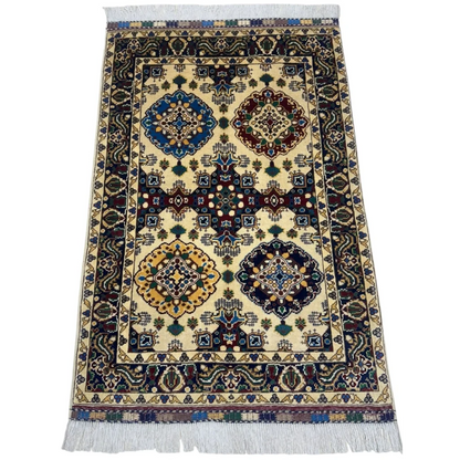 Handmade Afghan Kashi rug in beige with geometric floral patterns on cotton foundation