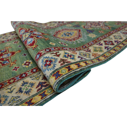 Handmade Afghan Kazak wool runner with cotton foundation, green rug with intricate geometric and floral designs in red, blue, yellow, and cream tones