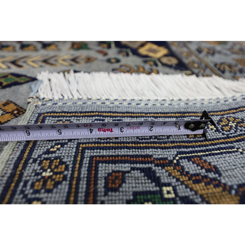 Measuring tape on handmade Afghan Zerkhaki rug with cotton foundation