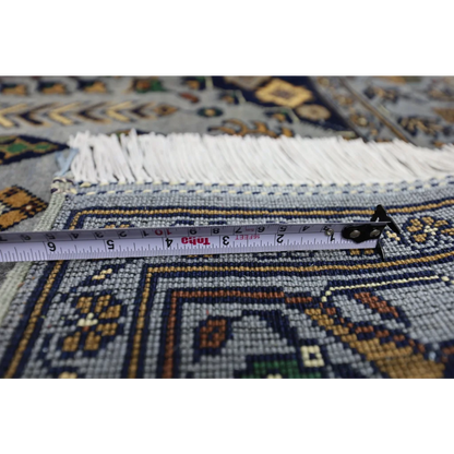 Measuring tape on handmade Afghan Zerkhaki rug with cotton foundation