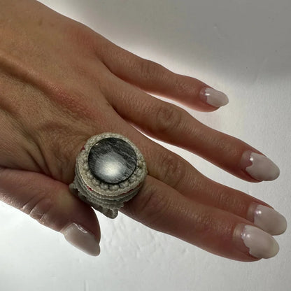 Chunky handmade woven ring with textured gray macrame band and black stone