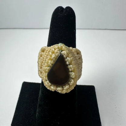 Cream-colored handmade woven ring with dark brown teardrop stone