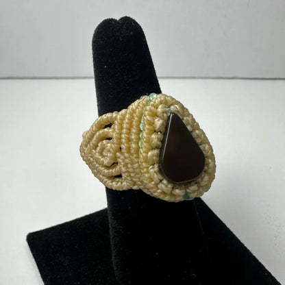 Cream-colored macrame handmade woven ring with dark brown teardrop stone center