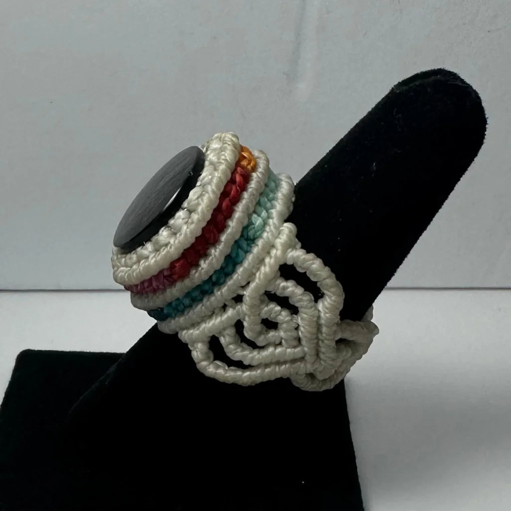 Handmade woven ring with black stone centerpiece in teal and red cords