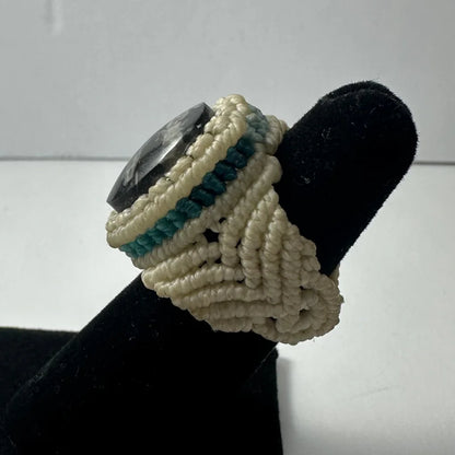 Handmade woven ring with dark polished stone and cream teal cords