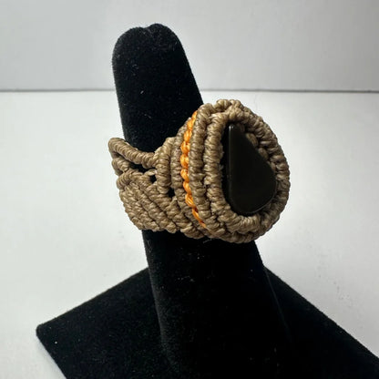 Handmade woven ring with black teardrop stone in beige orange cords