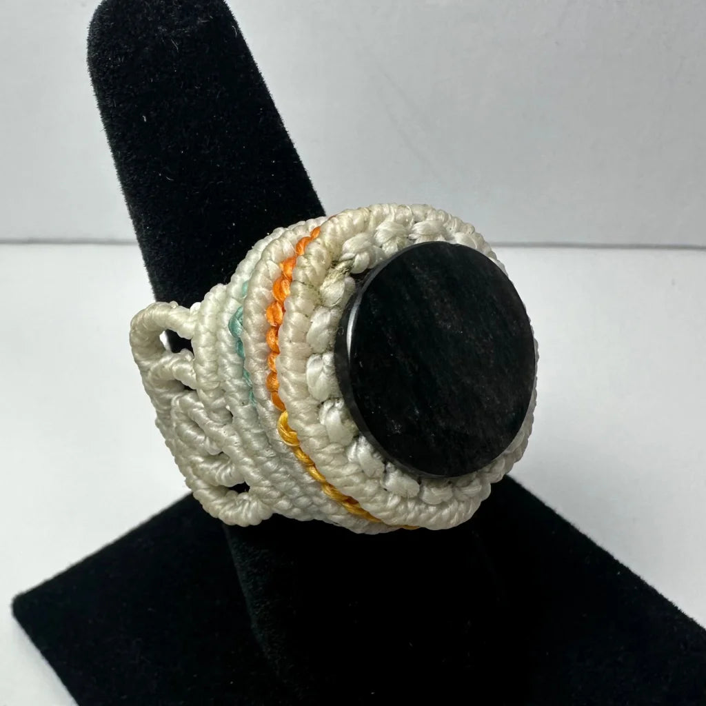Handmade woven ring with black stone in white, orange, green cords
