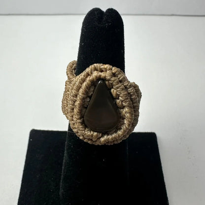 Handmade woven ring with dark teardrop stone in macrame knot band
