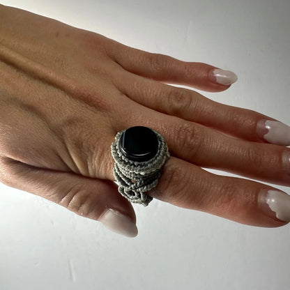 Handmade woven ring with smooth black stone in gray macrame band