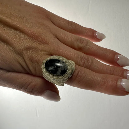 Handmade woven ring with dark oval stone in macrame beige band