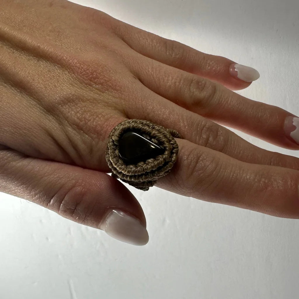 Handmade woven ring with dark smooth stone in brown macrame band