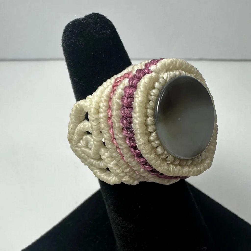 Handmade woven ring with intricate white mauve cords and gray stone center