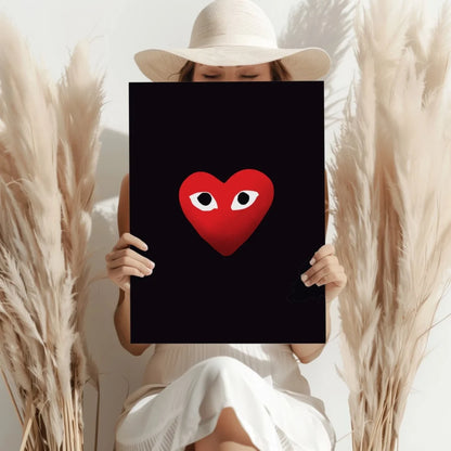 Vibrant red Comme des Garçons heart with white eyes on black insigne aluminum print