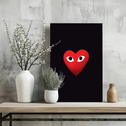 Red Comme des Garçons heart insigne aluminum print with eyes on black