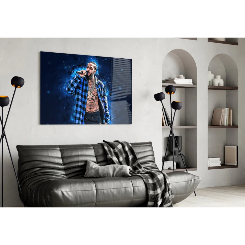 Black leather couch with checkered throw under hip hop wall art