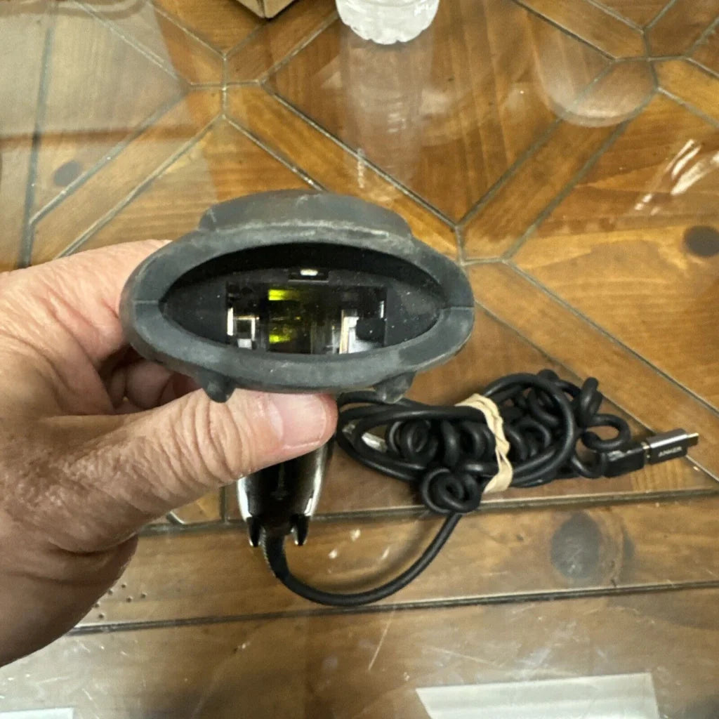 Honeywell black handheld barcode scanner with rubber grip and coiled USB cable
