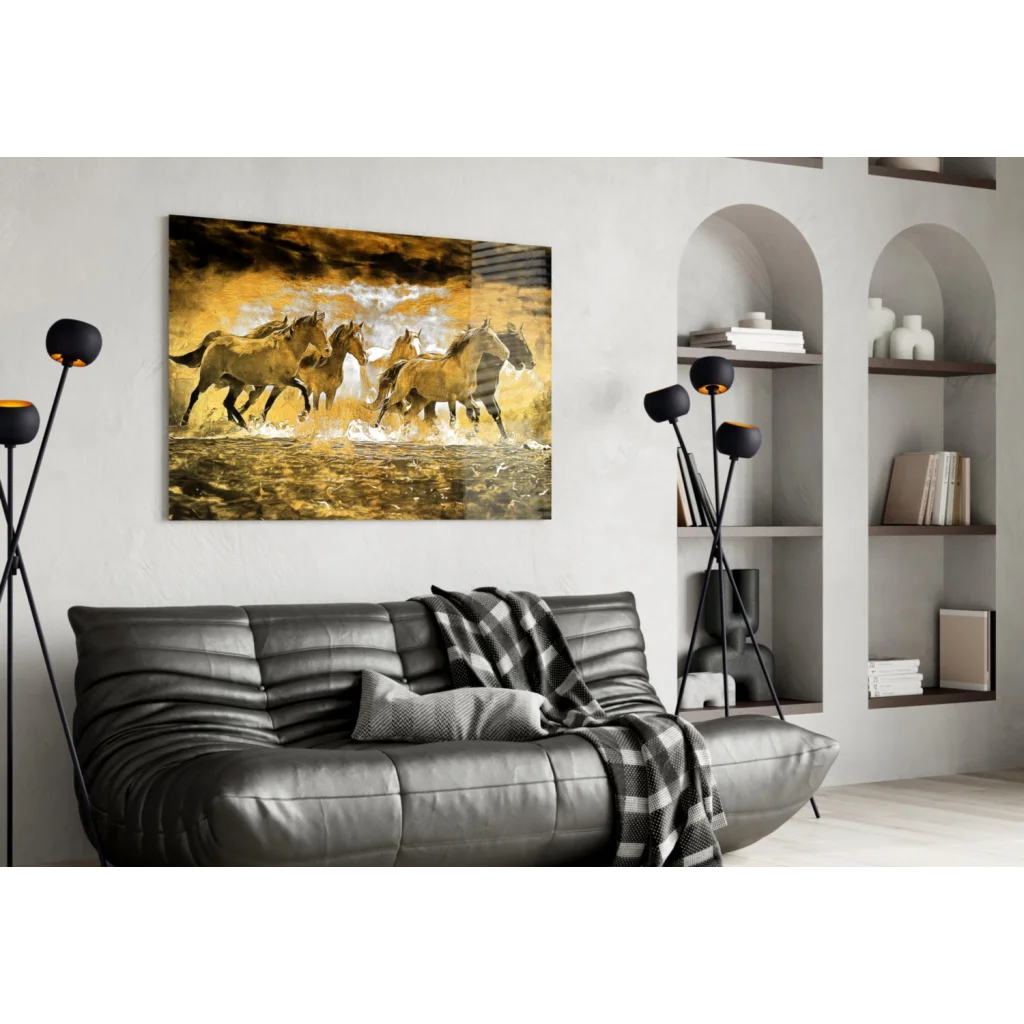Golden horses galloping in canvas wall art above black sofa
