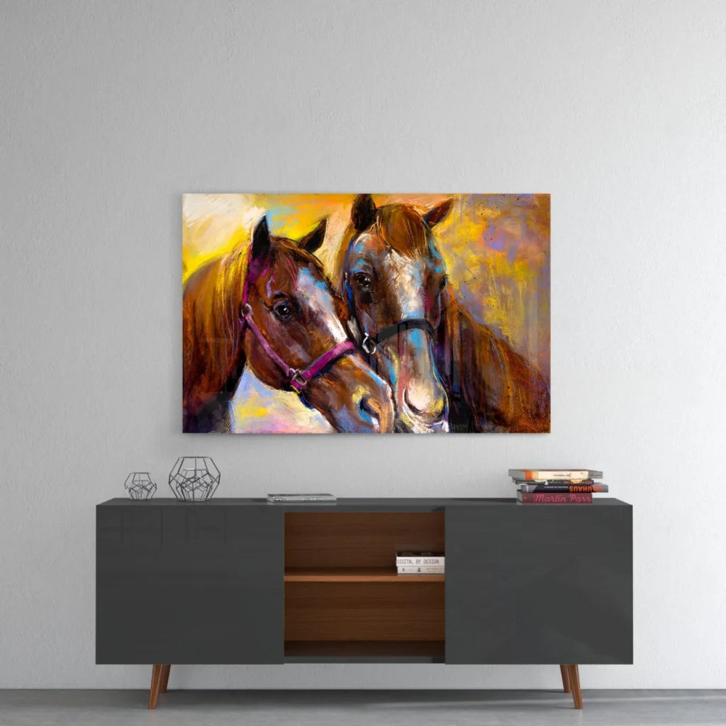 Vibrant abstract glass wall art of two brown horses in bold purple and black halters on warm yellow orange background