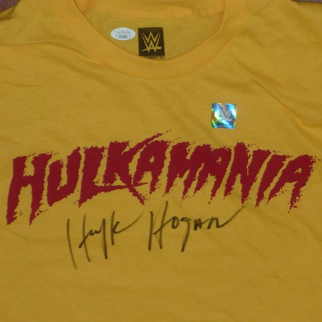 Yellow hulkamania t-shirt featuring a bold red graphic and hulk hogan autograph from a private signing with JSA authentication