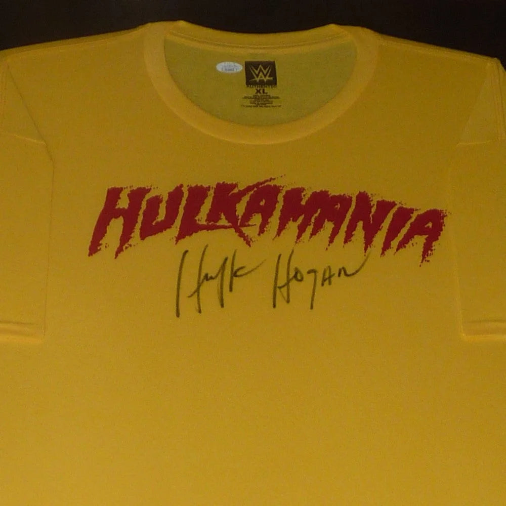 Yellow hulkamania wrestling t-shirt with red graffiti lettering and hulk hogan autographed black ink signature below framed deluxe