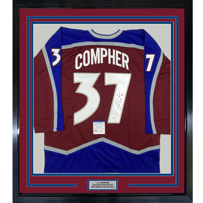 Framed maroon and blue Colorado Avalanche hockey jersey #37 signed by J.T. Compher with authentication certificate visible below.