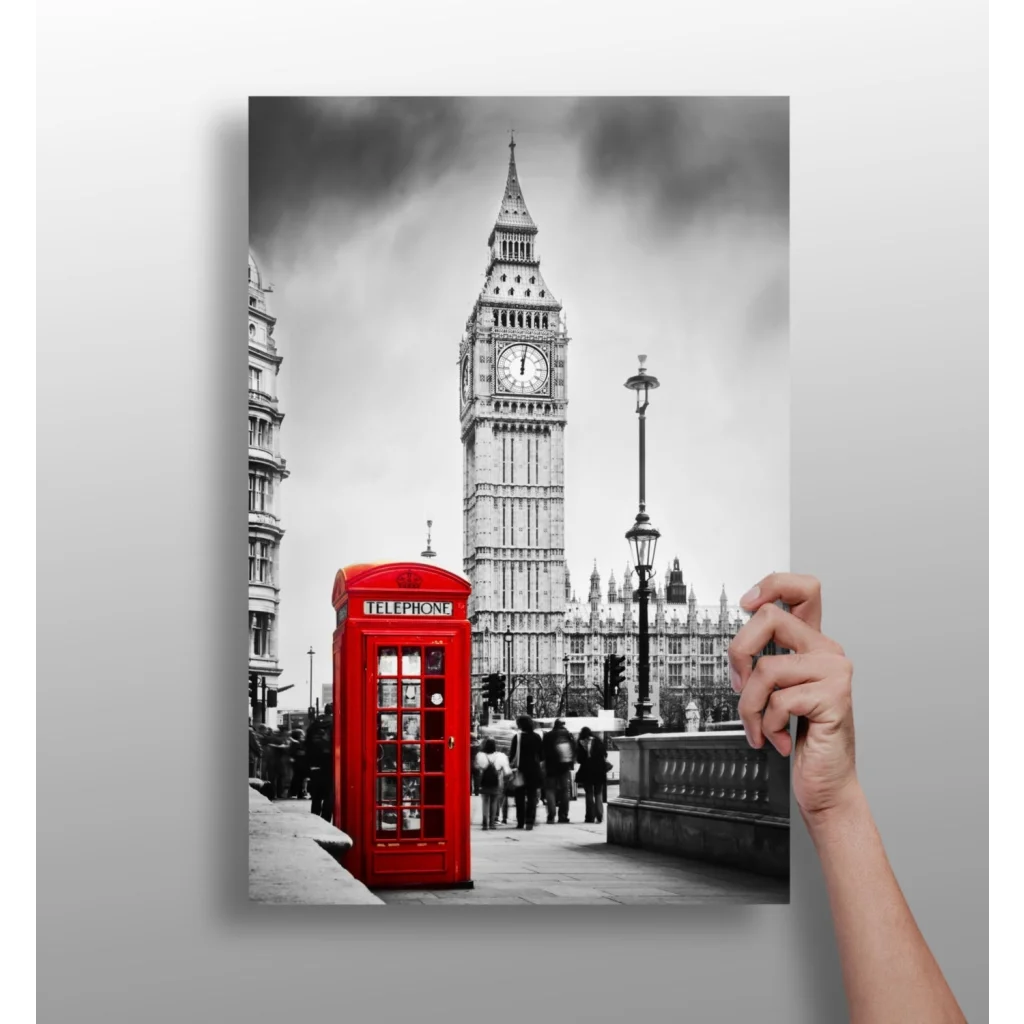 Vibrant red British phone booth against black-and-white Big Ben scene