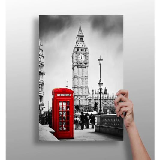 Vibrant red British phone booth against black-and-white Big Ben scene