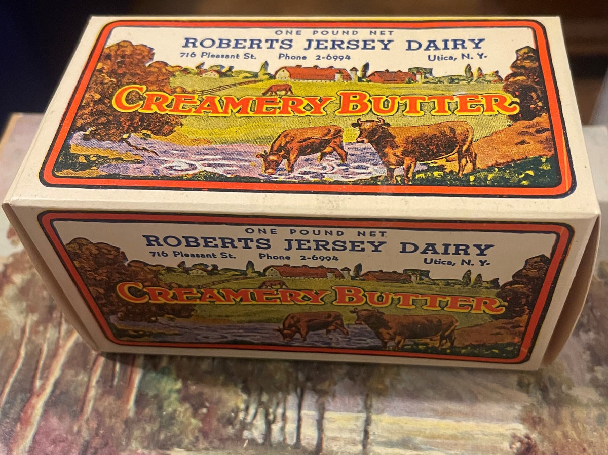 Vintage Roberts Jersey Dairy creamery butter box from Utica, NY showing pastoral farm scene with cows and red border design o