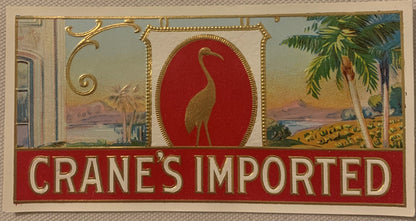 Vintage embossed cigar label featuring a gold crane on red background, ornate gold borders, and Egyptian riverside scenes on 