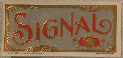 Antique gold-embossed cigar label reading "Signal" in red letters with decorative gold scrollwork border and small profile me