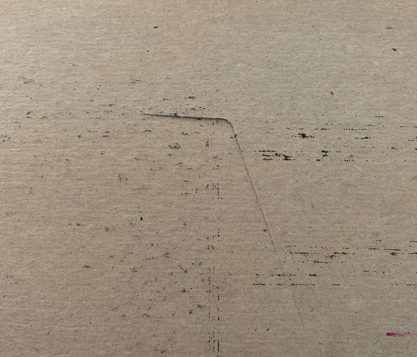 Cream-colored vintage meat packing label with dark printed text and scattered marks on textured paper surface