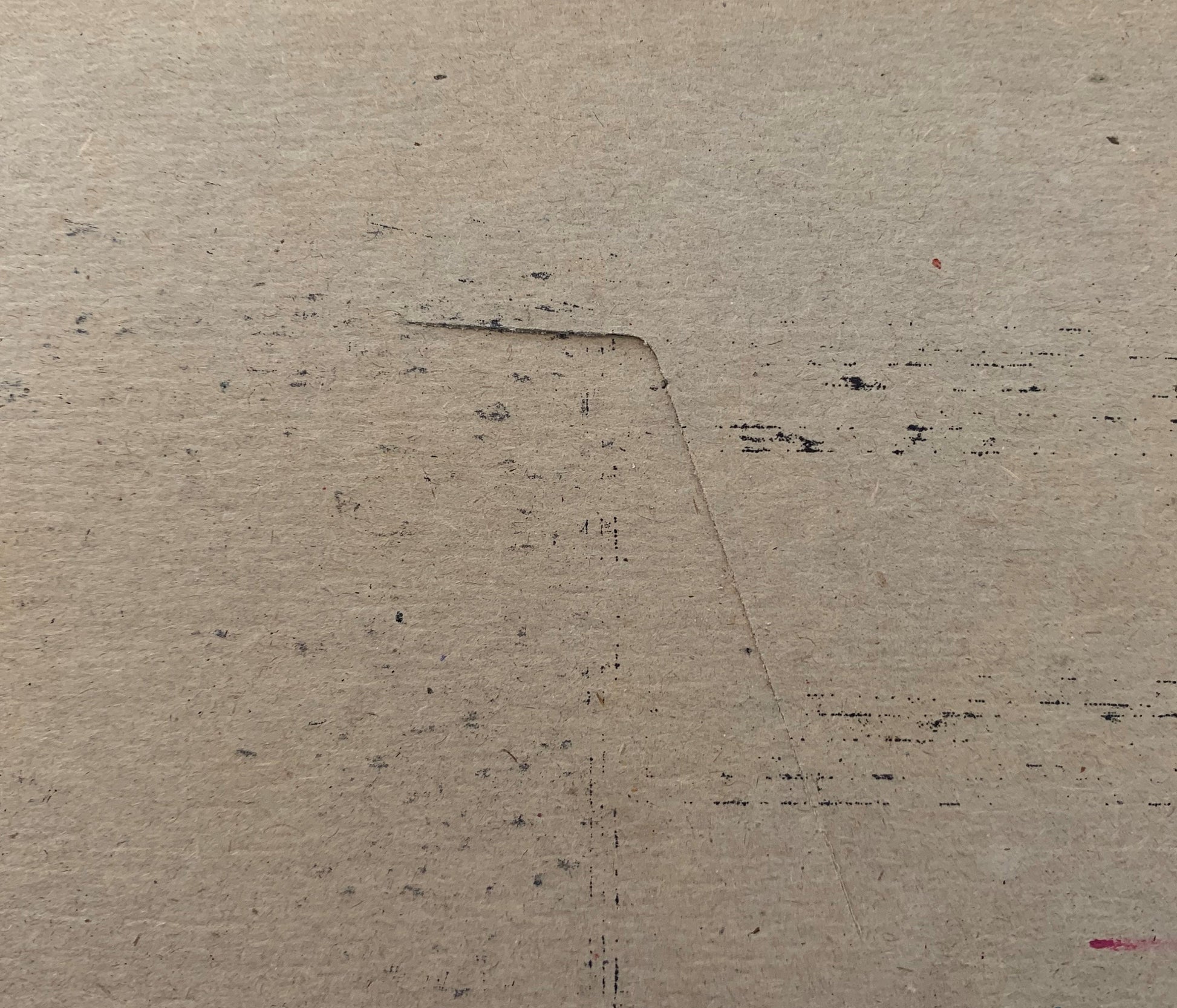 Cream-colored vintage meat packing label with dark printed text and scattered marks on textured paper surface