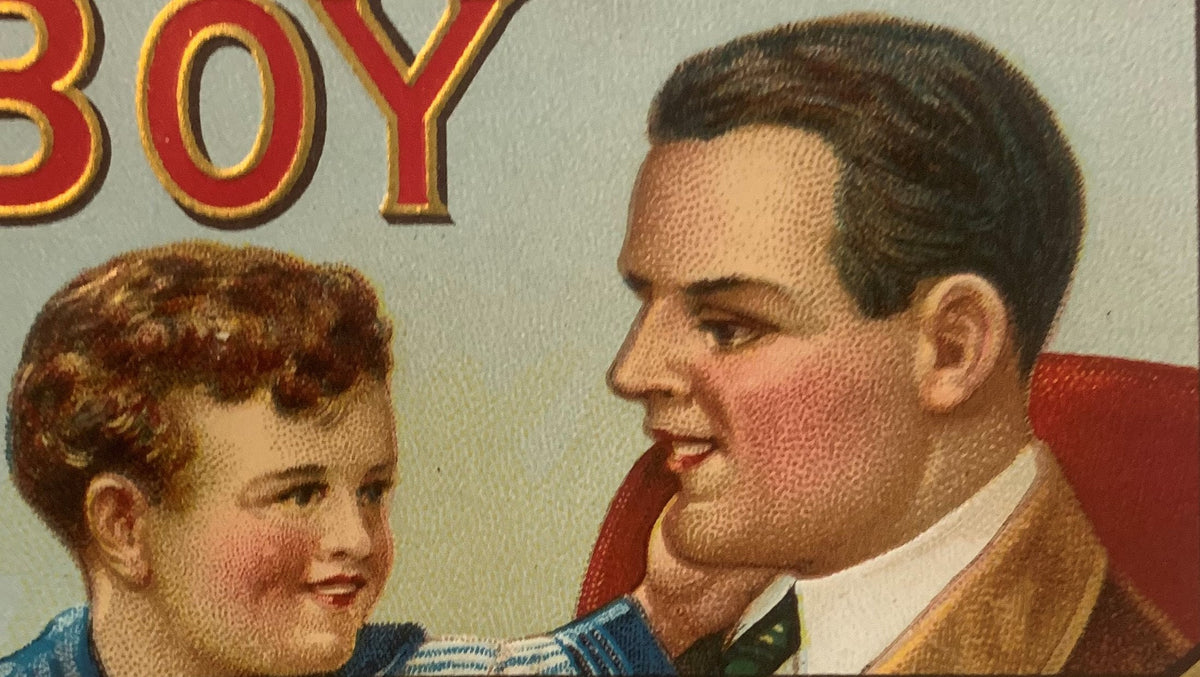 Vintage cigar box label showing an adult man and young boy in profile, with red and gold "BOY" text visible at top, embossed 