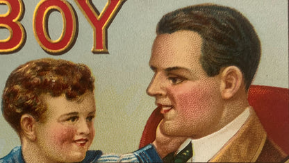 Vintage cigar box label showing an adult man and young boy in profile, with red and gold "BOY" text visible at top, embossed 
