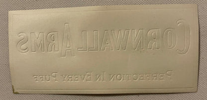 Back of the small Cornwall Arms label: plain cream paper with CORNWALL ARMS and the slogan pressed through in reverse by the embossing.