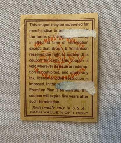 Vintage tobacco coupon from Brown & Williamson with tan background, brown border text, and red "TOBACCO" stamp overlay, cash 