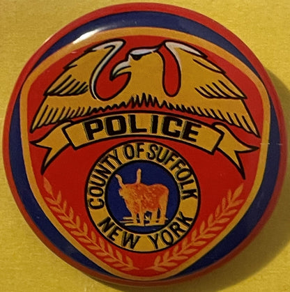 Vintage tin litho pin-back button featuring eagle, "Police" banner, and "County of Suffolk New York" seal in red, gold, and n