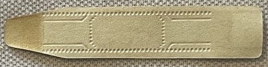 Gold embossed cigar band label with decorative dotted borders on tan fabric backing, photographed flat against textured surfa